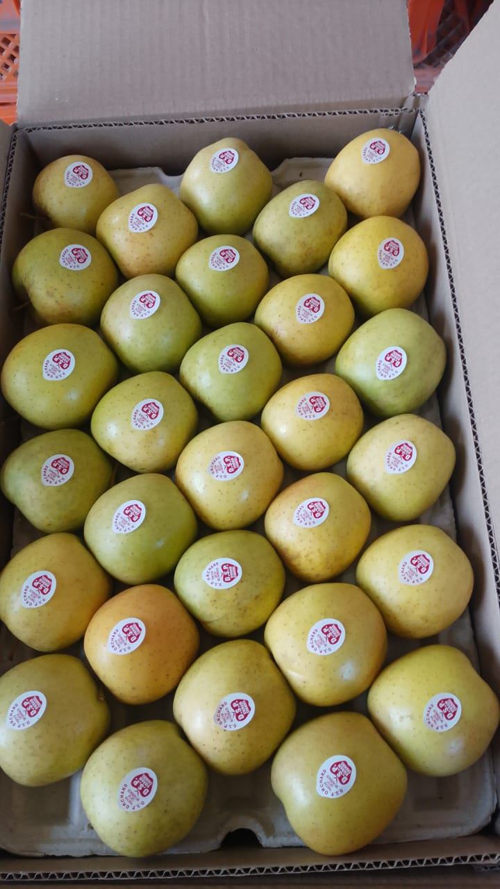 Close-up of golden apples in the box